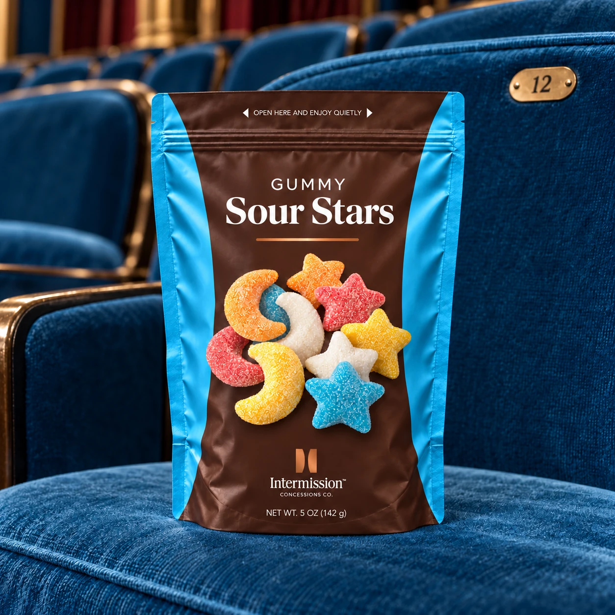 Intermission Gummy Sour Stars pouch on a blue theater seat