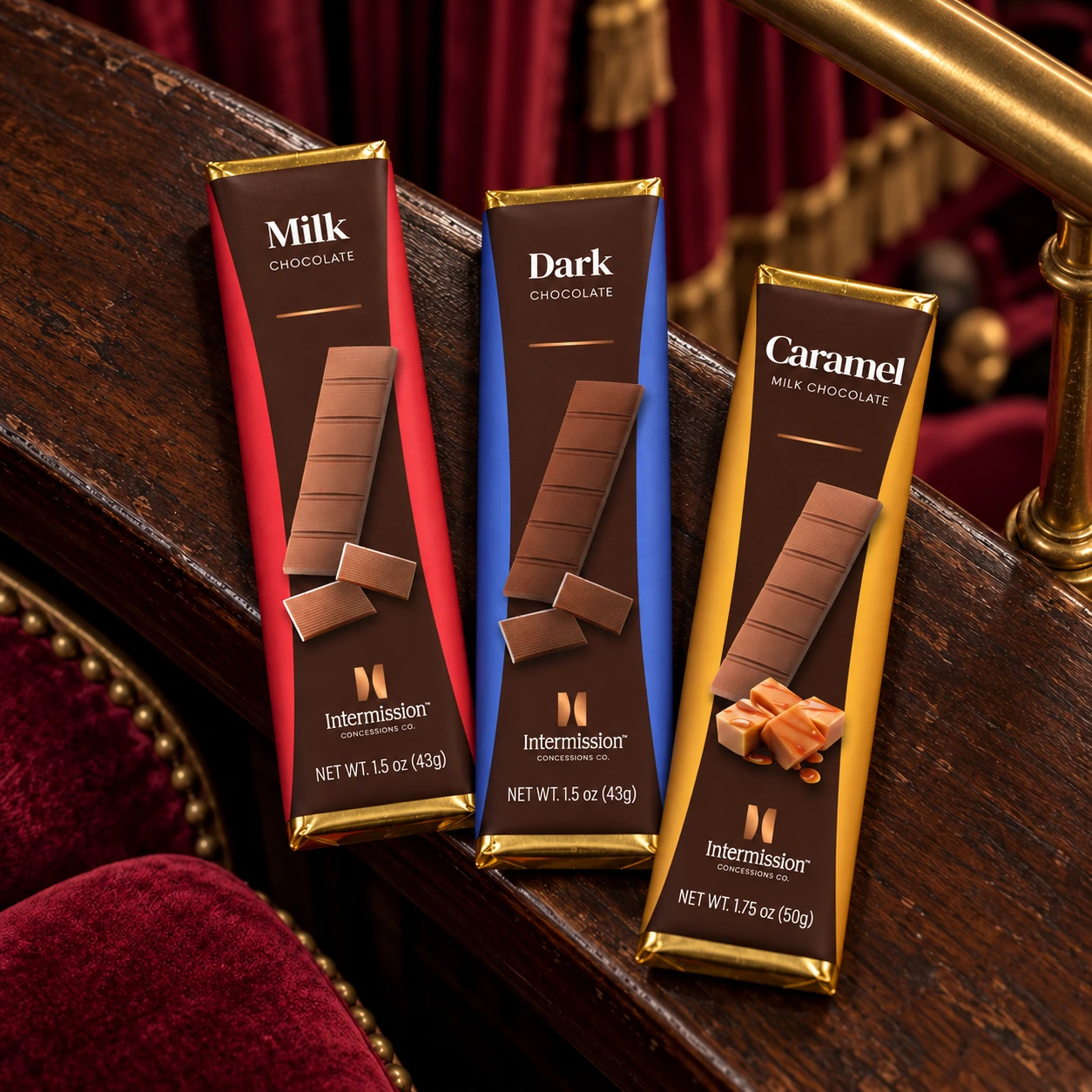 Intermission Milk, Dark and Caramel chocolate bars on a walnut theater ledge with burgundy velvet