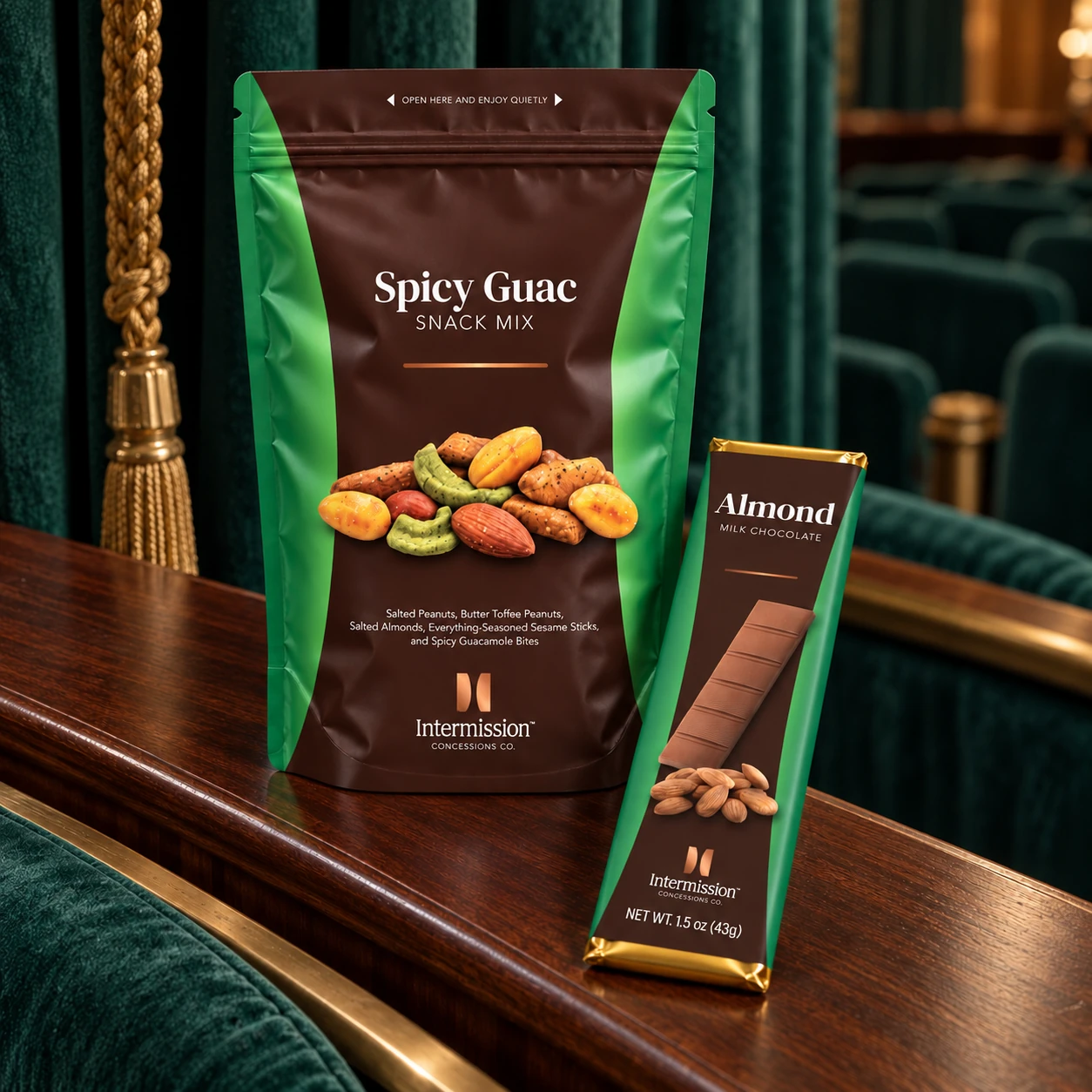 Intermission Spicy Guac Snack Mix and Almond Milk Chocolate bar against green theater curtains
